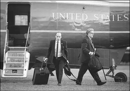  ?? AL DRAGO / THE NEW YORK TIMES ?? Stephen Miller, left, a White House senior adviser, and Steve Bannon, then President Donald Trump’s chief strategist, deplane April 9 from Marine One at the White House. California, a bright blue bulwark of antiTrump politics, has become a source of...