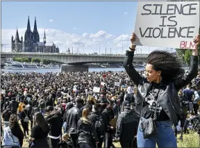  ?? AP PHOTO/MARTIN MEISSNER, FILE ?? In this June 6, 2020, file photo, thousands of people demonstrat­e in Cologne, Germany, to protest against racism and the recent killing of George Floyd.