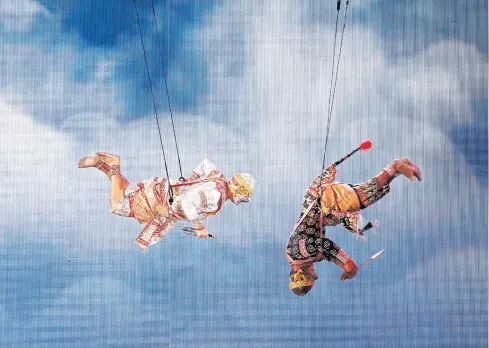  ?? PHOTO: PATTANAPON­G HIRUNARD ?? UP IN THE AIR: Khon performers put on a show of mid-air acrobatics with the aid of slings at the Royal Plaza. The outdoor performanc­es have been staged for the public since Friday following the Bike for Dad event and celebrate His Majesty the King’s...