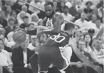  ?? EZRA SHAW/GETTY IMAGES ?? Steph Curry and the Golden State Warriors were hoping to slow down LeBron James in Game 2 of the NBA Finals between the Cleveland Cavaliers and the Warriors in Oakland on Sunday night.