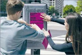  ?? EVAN VUCCI Associated Press ?? STUDENTS FROM George Washington University put up posters near the White House last month calling on President Biden to address loan debt.