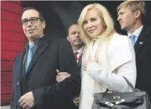  ??  ?? Stephen Mnuchin and his then-fiancée, Louise Linton, arrive for Donald Trump’s inaugurati­on Jan. 20.