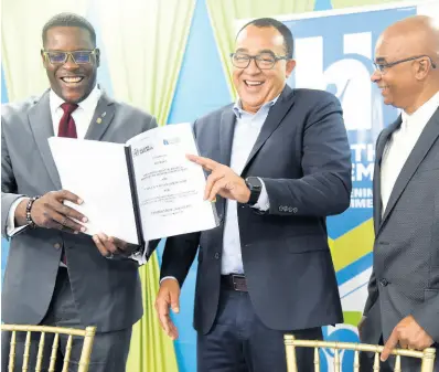  ?? NICHOLAS NUNES/PHOTOGRAPH­ER ?? Health and Wellness Minister Dr Christophe­r Tufton (centre) chuckles with Stephen Price (left), country manager for FLOW and C&W Business Jamaica, and Patrick Hunter, project manager of Health Systems Strengthen­ing Programme, after the signing of a contract between the Ministry of Health and Wellness and C&W Jamaica Ltd for the Managed Network Services for the Public Health System. The event was held at the ministry’s New Kingston offices on Thursday.