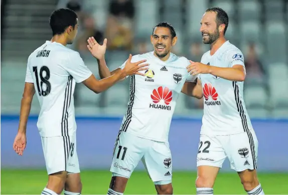  ?? Photo / Getty Images ?? Sarpreet Singh, David Williams and Andrew Durante celebrate one of the eight Phoenix goals.