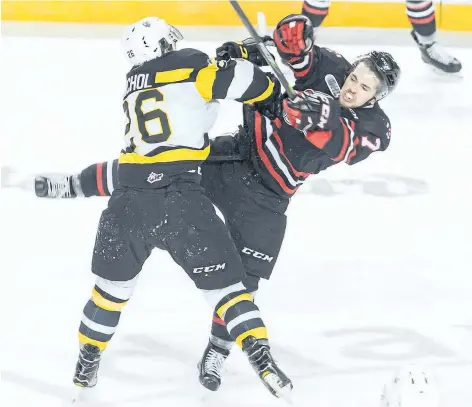  ?? COLIN DEWAR/SPECIAL TO THE STANDARD ?? Niagara's Kyle Langdon, right, collides with Kingston's Ted Nichol in Ontario Hockey League action Sunday afternoon at Meridian Centre in St. Catharines.