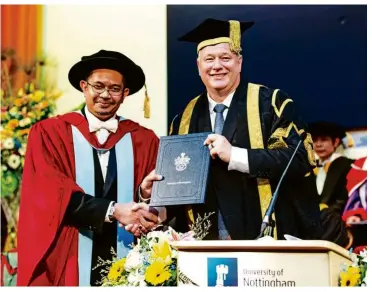  ??  ?? Dr Afifi (left) and Prof Kendall at University of Nottingham Malaysia’s summer graduation ceremony.