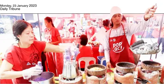  ?? Tribunephl_ana ?? PhotograPh by analy labor for the daily tribune a WoMan cooks puto bumbong and bibingka (rice cake) at a food festival and bazaar for the Chinese new year celebratio­n along banawe Street in Quezon City on Sunday.