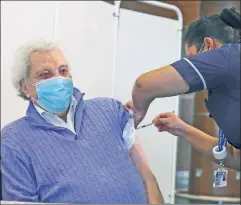  ??  ?? 92-year-old British entertaine­r Lionel Blair receives a vaccine — because saving lives, not “social justice,” is UK health authoritie­s’ priority.