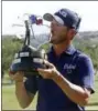  ?? MICHAEL THOMAS — THE ASSOCIATED PRESS ?? Andrew Landry kisses the trophy for the Valero Texas Open, Sunday in San Antonio. Landry won with a score of 17 under par.
