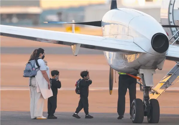  ??  ?? NRL players’ loved ones board a plane at Bankstown Airport to join the bubble in Queensland. Picture: Jonathan Ng