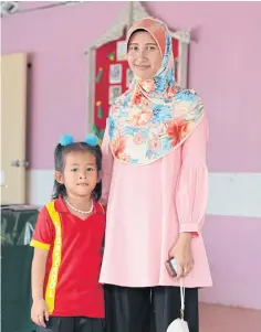  ??  ?? LOST FOR WORDS: Rohkiyoh Abu and her daughter, Afifa. Ms Rohkiyoh hopes that her daughter won’t face the challenges she had with learning Thai.