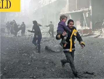  ?? ABDULMONAM EASSA / AFP / GETTY IMAGES ?? A man rescues an infant after a bombing raid on the outskirts of the Syrian capital Damascus on Sunday. At least 71 people were killed and more than 300 were injured in 24 hours of intense bombing in eastern Ghouta, observers said.