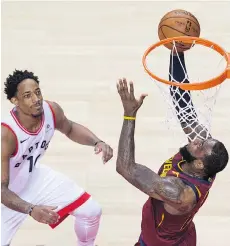  ?? TYLER ANDERSON ?? The Raptors’ DeMar DeRozan can only watch in vain as Cleveland star LeBron James gets an easy look at the basket during the Cavaliers’ 128-110 victory in Game 2 of their series in Toronto.