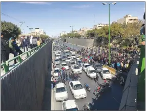  ?? AP ?? Cars block a street Saturday during a protest against a rise in gasoline prices in the central city of
Isfahan, Iran.