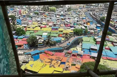  ?? – AFP ?? This aerial picture shows a view of houses painted in bright colours at a fishing area in Mumbai.