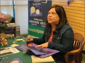  ?? Emily Alvarenga/The Signal ?? (Above) Local author Karen Jameson signs books at the launch of “Moon Babies” Saturday at Barnes & Noble in Valencia. (Below, left) Preston Owens, 3, plays with the telescope he made at the book launch. (Below, right) Krystal Briscoe helps her 18-month-old daughter, Kinsley, create space crafts at the event.