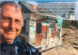  ??  ?? Paul Morrison with the night hide on the jetty for guarding the terns. It is twinned with a cafe bar in Paris called Le Refuge. They held a fundraisin­g event for Coquet