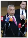  ?? (AP/Virginia Mayo) ?? Hungary’s Prime Minister Viktor Orban speaks with the media Thursday as he arrives for an EU summit at the European Council building in Brussels.