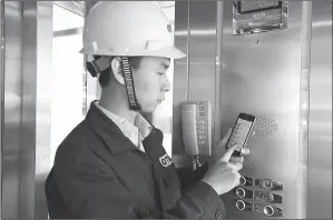  ?? PHOTOS PROVIDED TO CHINA DAILY ?? A technician uses a mobile device and a cloud computing-based app to service an Otis Elevator. The company hopes to utilize new technology to enhance efficiency of service.