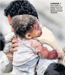  ??  ?? CARNAGE A boy’s body is pulled from the rubble. Picture: Reuters/Khaled Abdullah