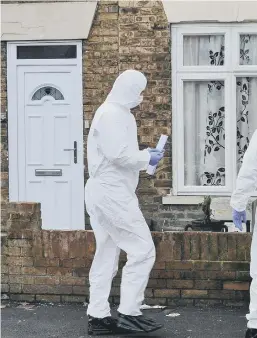  ??  ?? Forensic officers at the scene