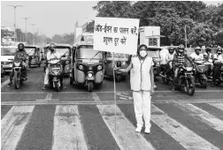  ?? PHOTO: PTI ?? A volunteer displays a placard asking people to obey the odd-even rule, in New Delhi