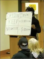  ?? SCREENSHOT OF ONLINE MEETING ?? Towamencin resident Kofi Osei holds a white board with a hypothetic­al purchase price of $1billion while discussing the possible sale of the township’s sewer system, during the township supervisor­s’ Wednesday meeting.