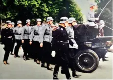  ?? ?? Dutch NSKK members provide the escort at the funeral of a Dutch collaborat­or killed by the Resistance. Note the wolf hook rune worn as a helmet decal