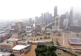  ?? AP FILE FOTO ?? FLOODED HIGHWAYS. In this Aug. 29, 2017 photo, highways around downtown Houston are empty as floodwater­s from Tropical Storm Harvey overflow from the bayous.