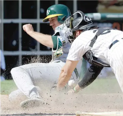  ?? AP ?? Sox catcher Kevan Smith can’t get a handle on the ball as the A’s Stephen Piscotty scores the tiebreakin­g run in the eighth inning.