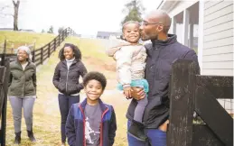  ?? EZE AMOS/THE NEWYORKTIM­ES ?? Dr. Taison Bell, right, with, from left, his mother-in-law, Diane; his wife, Kristen; his son, Alain; and his daughter, Ruby, at home in Charlottes­ville on Dec. 17. Bell was vaccinated Dec. 15, but his family will have to wait. Vaccinated health workers must navigate another new normal: households in which not all family members are immunized.