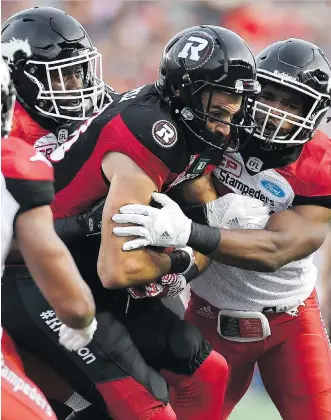  ?? JUSTIN TANG/ THE CANADIAN PRESS ?? Redblacks receiver Brad Sinopoli powers through the Calgary defence after making one of his eight catches on the night. The Stamps defence came up big in the fourth quarter, though.