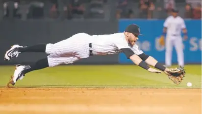  ?? Jack Dempsey, The Associated Press ?? Rockies shortstop Trevor Story misses the ball on a single by New York Mets' Asdrubal Cabrera during the sixth inning of a baseball game Wednesday at Coors Field.