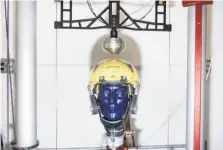  ?? Michael Short / Special to The Chronicle ?? A prototype football helmet is strapped to a test dummy’s head on an impacttest­ing drop rig at Brainguard Technologi­es in Richmond. Brainguard is addressing “rotational force” that twists the brain.