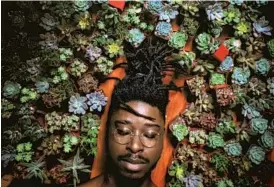  ?? Nelson ZêPequéno ?? THE INSTAGRAM account of Nelson ZêPequéno, below in a self-portrait, highlights Black men who care for plants.