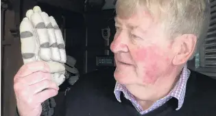  ?? PHOTO: CRAIG BAXTER ?? Treasured memento . . . Russell Stewart, of Dunedin, holds the cricket batting glove he thought he lost on the Wahine, only to have it returned to him months after the disaster.