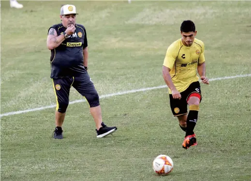  ??  ?? Argentine legend Diego Maradona (left) conducts his first training session as coach of Mexican football club Dorados. As much as he was a genius with the ball at his feet, Maradona’s coaching career has been far from distinguis­hed. — AFP