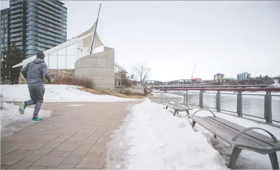  ?? LIAM RICHARDS ?? A jogger heads along River Landing Wednesday as snow, ice and grey skies serve as a reminder that winter isn’t quite yet done with Saskatchew­an.