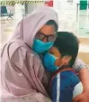  ??  ?? Khadija and her son Moiz in an emotional reunion at Dubai airport.