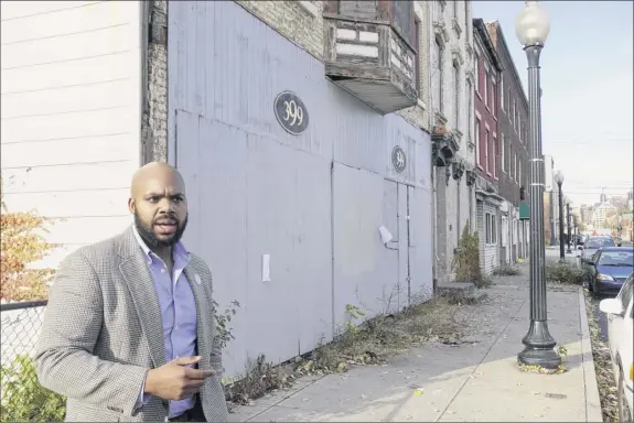  ?? Paul Buckowski / Times Union ?? Jahkeen Hoke, COO in charge of strategic planning and developmen­t for Upstate New York Black Chamber of Commerce, stands on South Pearl Street and talks about plans to bring entreprene­urs to the empty buildings in Albany. Hoke grew up in this neighborho­od.