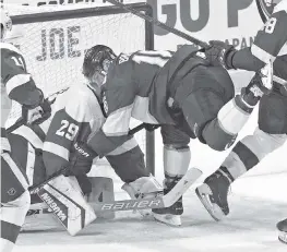  ?? CHARLES TRAINOR JR ctrainor@miamiheral­d.com ?? The Panthers’ Aleksander Barkov (16) crashes into Red Wings goalie Thomas Greiss in the first period Sunday at the BB&T Center.