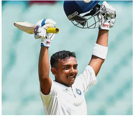  ?? — AFP ?? A legend in the making: India’s ‘boy wonder’ Prithvi Shaw celebrates after scoring a century in his first Test match against West Indies at the Saurashtra Cricket Associatio­n Stadium in Rajkot on Oct 4.