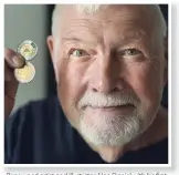  ??  ?? Renowned artist and illustrato­r Alan Daniel with his first circulatio­n coin. His design depicts Canadian soldiers ready to land at Juno Beach on June 6, 1944.