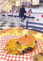  ?? GREG SORBER/JOURNAL ?? Laguna Burger, home of a much-vaunted green chile cheeseburg­er shown here with smothered fries, will open its latest outlet — and the first one in Albuquerqu­e proper — at Avanyu Plaza in early November.