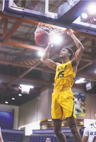  ?? Fred Gladdis / Davis Enterprise ?? USF’s Nate Renfro throws down a dunk in the Dons’ romp at UC Davis. Renfro had seven points and six rebounds. The Dons shot 52.5 percent from the floor. The Aggies were at 27.5 percent.