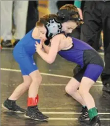  ?? DiGitAl FiRSt MeDiA File PHOtO ?? two little guys, Phoenixvil­le’s Colt Frost, right, and Brandywine’s Joshua Vance, tangle during the PAl youth wrestling meet.