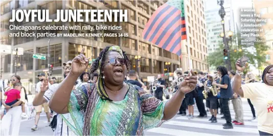  ?? ANTHONY VAZQUEZ/ SUN-TIMES ?? A woman waves a flag Saturday during a Juneteenth celebratio­n at Daley Plaza.