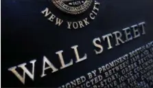  ?? MARK LENNIHAN — THE ASSOCIATED PRESS FILE ?? An historic marker on Wall Street in New York is shown. On Thursday global stocks were subdued as investors assessed the scant details of President Donald Trump’s U.S. tax overhaul.