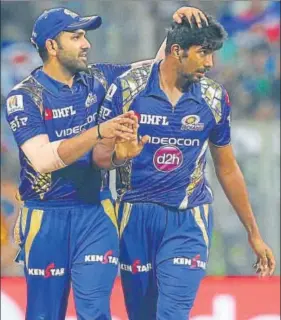  ?? AP ?? Mumbai Indians' Jasprit Bumrah is congratula­ted by skipper Rohit Sharma after he dismissed Sunrisers Hyderabad's Ben Cutting in Mumbai on Wednesday. Bumrah took three wickets for 24 runs.