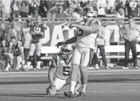  ?? STEVEN SENNE/AP ?? Panthers kicker Graham Gano, right, watches his game-winning field goal with holder Michael Palardy (5) against the Patriots on Sunday in Foxborough, Mass.